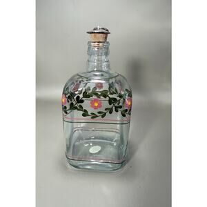 A Casafina Portugal hand-painted decanter featuring pink flowers and green vines